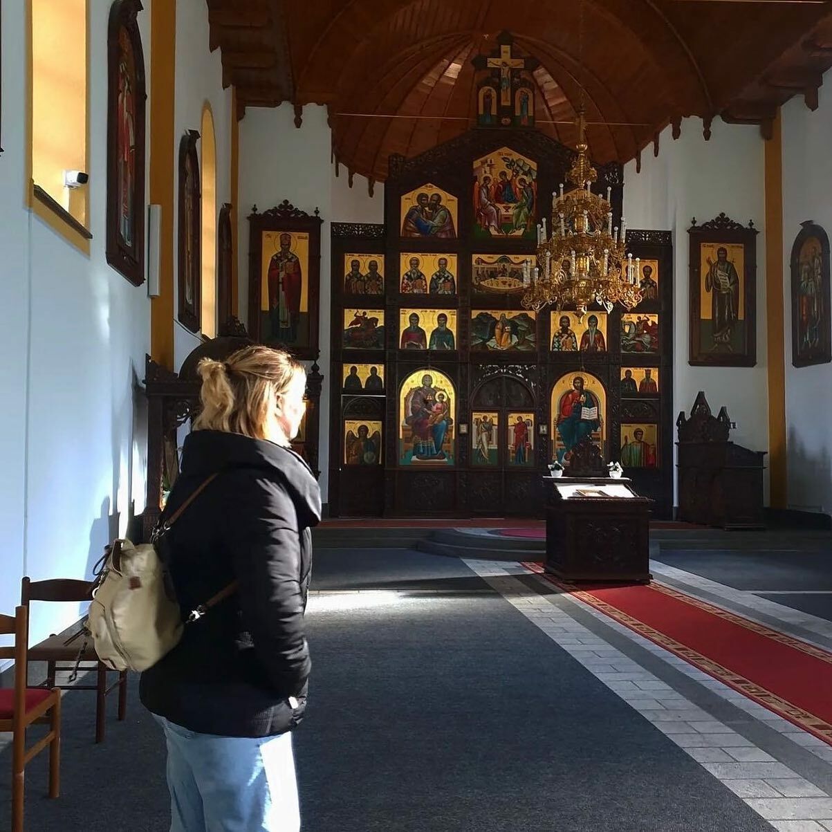 YES Abroad participant with back to camera, looking at the artwork in a Bosnian monestary