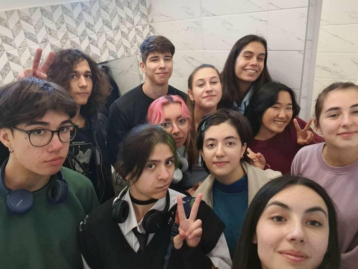 Emi surrounded by a group of friends.