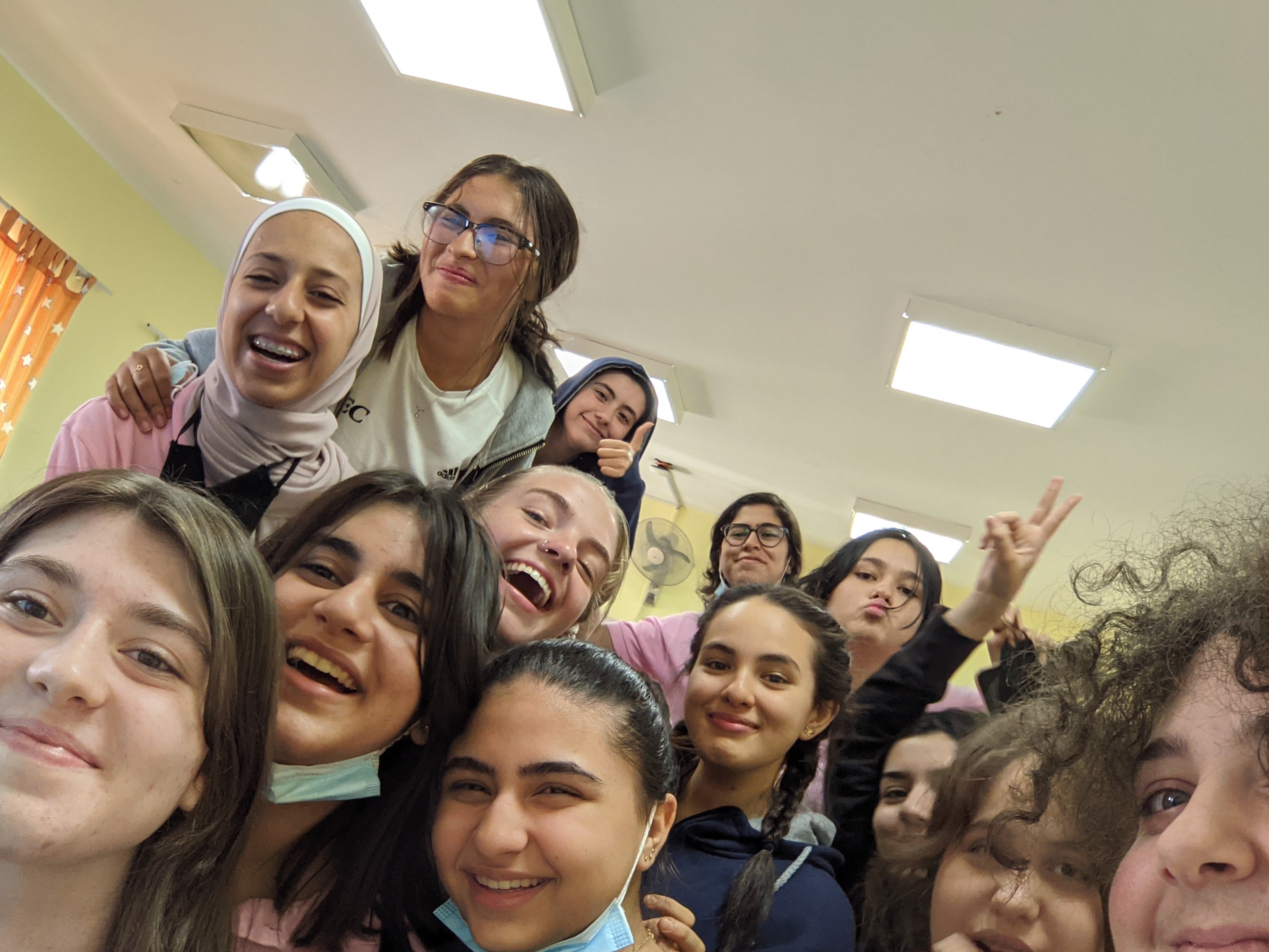 YES Abroad student Gaby with 12 classmates in Jordan