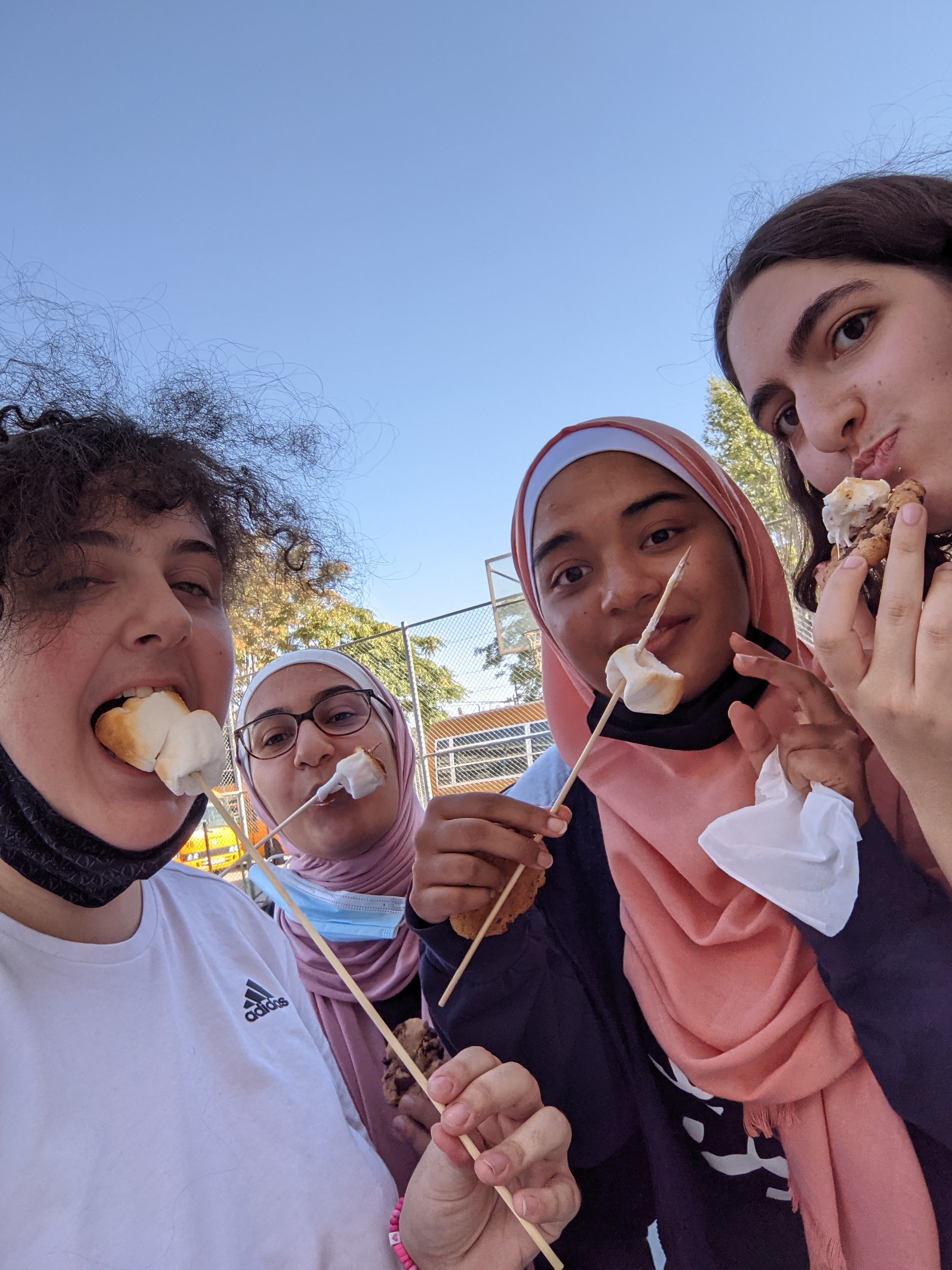 Gaby eating marshmallows with three friends