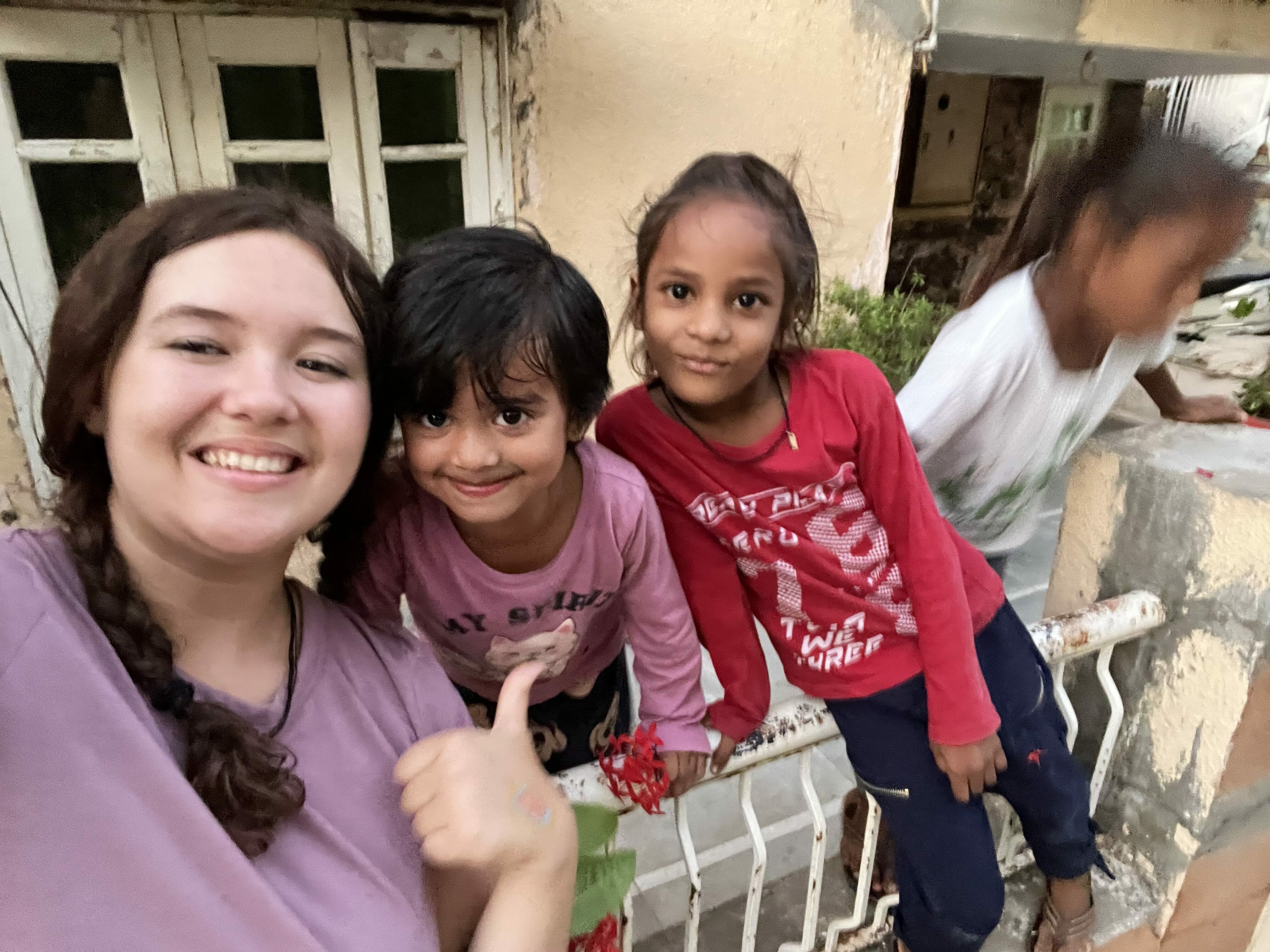 Kacey smiling with neighborhood children