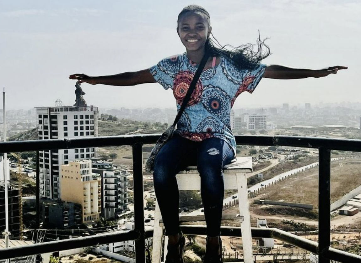 Lauryn posing for a picture with a city background
