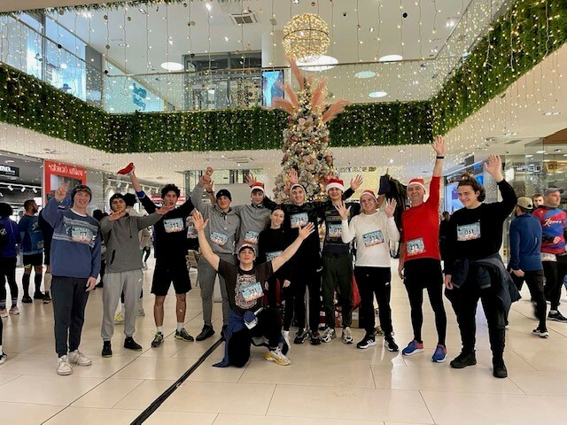 The adventure club group photo in front of a Christmas tree