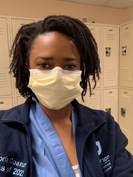 Headshot of Victoria wearing a face mask at the hospital