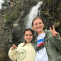 Peri Posing With Host Sister In Front Of A Waterfall