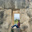 Alex in a doorway of ruins