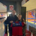 YES Abroad student, Clara standing next to her host dad and holding a Handball jersey