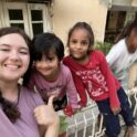 Kacey smiling with neighborhood children
